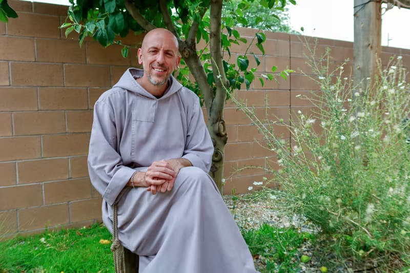 Fr. Jeremiah smiling in a garden