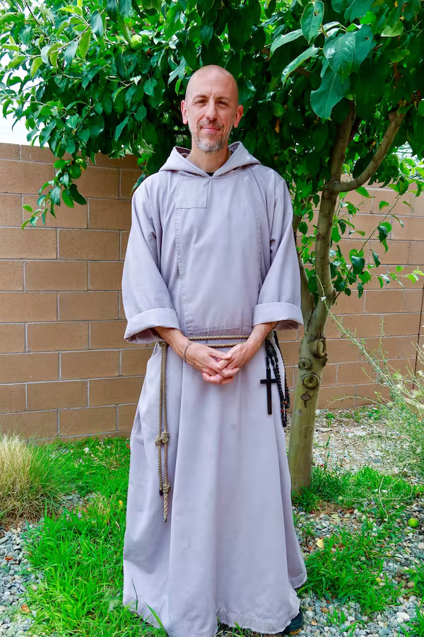 Father Jeremiah by a tree